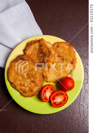 Potato pancakes with meat and tomatoes on green Potato pancakes with meat and tomatoes on green 63219379