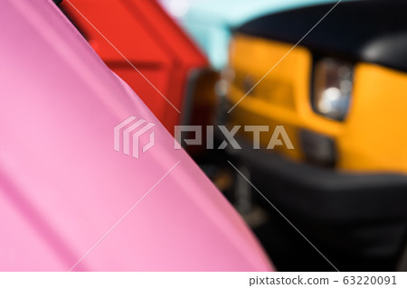 Two small cars of different colors on the road Two small cars of different colors on the road 63220091
