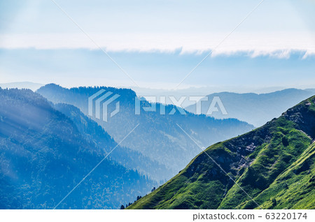 Green mountain slope. Layers of mountains in the haze during sunset Green mountain slope. Layers of mountains in the haze during sunset 63220174
