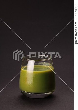 Green detox juice over black background. Green detox juice over black background. 63220955