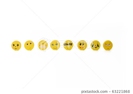 A few yellow round discs with funny faces 63221868