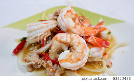 Sour shrimp salad in a bowl on the lunch table. Sour shrimp salad in a bowl on the lunch table. 63223428