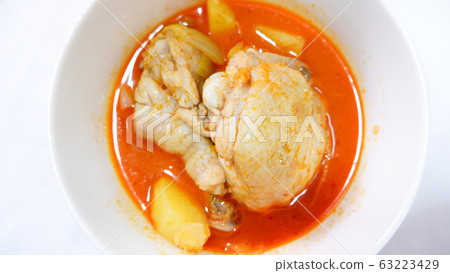 Massaman curry with chicken and potatoes In a bowl on the table . Massaman curry with chicken and potatoes In a bowl on the table . 63223429