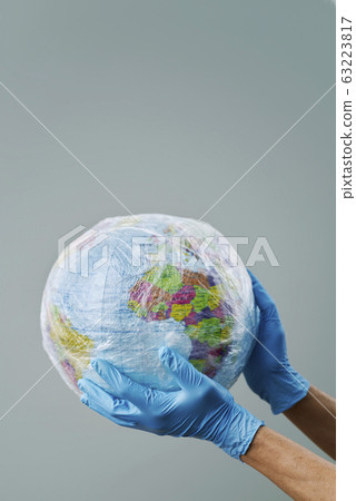 doctor with a world globe wrapped in plastic. doctor with a world globe wrapped in plastic. 63223817