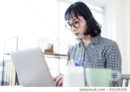 A woman working at the window seat A woman working at the window seat 63224300