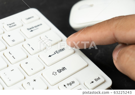 his finger put on the enter text of computer keyboard his finger put on the enter text of computer keyboard 63225243