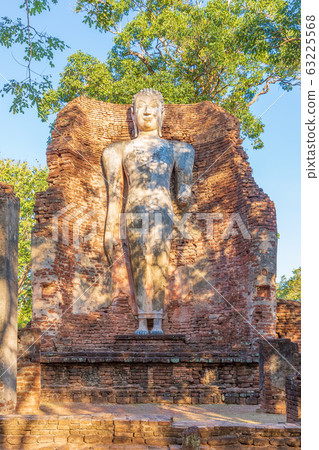Standing Buddha statue at Wat Phra Si Ariyabot Standing Buddha statue at Wat Phra Si Ariyabot 63225568