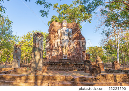 Standing Buddha statue at Wat Phra Si Ariyabot Standing Buddha statue at Wat Phra Si Ariyabot 63225590