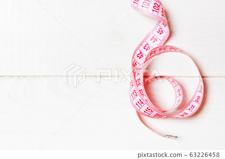 Top view of measure tape curtailed into a spiral Top view of measure tape curtailed into a spiral 63226458