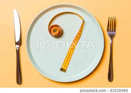 Question mark made of measuring tape on round Question mark made of measuring tape on round 63226460
