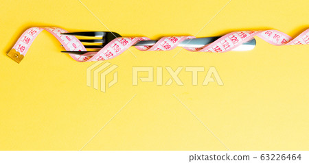 Composition of curled wrapped measuring tape and 63226464