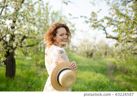 Young attractive woman with curly hair in a 63226587