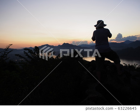 beautiful silhouette with evening landscape scene view background at PHU SI temple above LUANG PRABANG province in LAOS, a cute lovely UNESCO cultural heritage beautiful silhouette with evening landscape scene view background at PHU SI temple above LUANG PRABANG province in LAOS, a cute lovely UNESCO cultural heritage 63226645