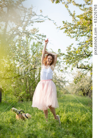 Young attractive girl walks in spring green park Young attractive girl walks in spring green park 63226768