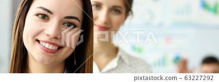 Young beautiful smiling clerk in office looking in camera Young beautiful smiling clerk in office looking in camera 63227292