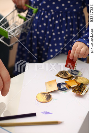 Little girl arm collecting crypto coins Little girl arm collecting crypto coins 63227528