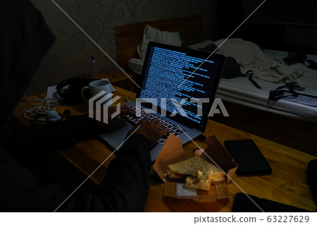 Computer hacker in hotel room 63227629