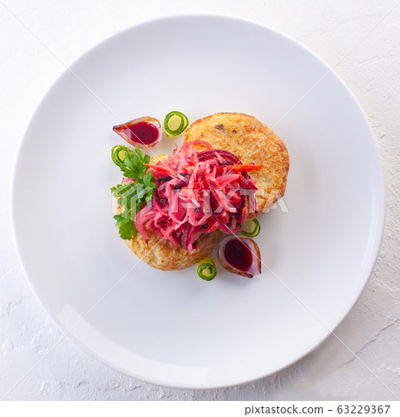 potato pancakes with vegetable salad and herbs 63229367