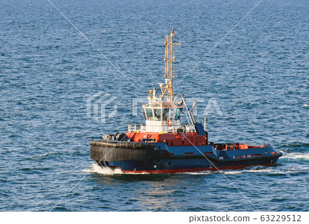 A tugboat navigates on the sea 63229512