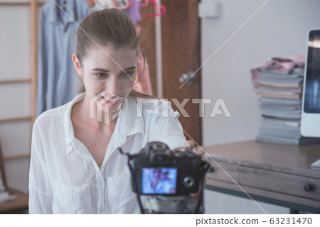 Blogger of caucasian woman with review product and Blogger of caucasian woman with review product and 63231470