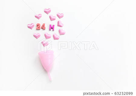 Pink menstrual cup on white background with hearts 63232099