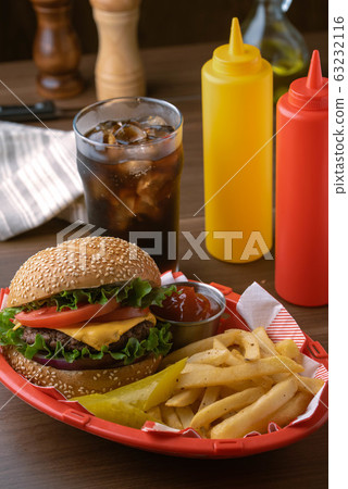 cheese burger and french fries in plastic basket 63232116