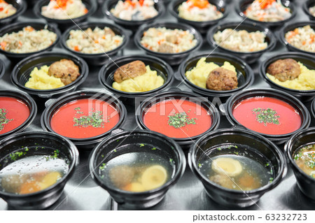 Row of plastic disposable lunch box with healthy natural food. Soups, cream soup, main course with side dish, salads. Food delivery. Lunch in the office. Row of plastic disposable lunch box with healthy natural food. Soups, cream soup, main course with side dish, salads. Food delivery. Lunch in the office. 63232723