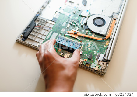 memory module ddr4 ram installation in laptop by hand 63234324