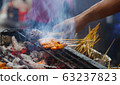 Grilled Pork Satay is marinated pork skewer stick barbecued on charcoal fire grill. 63237823