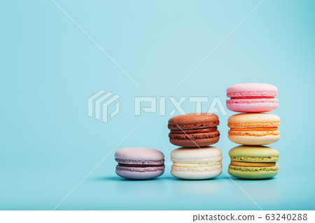 Macaroni cookies of different colors are arranged 63240288