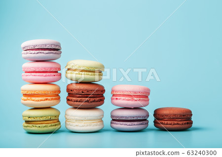 Macaroni cookies of different colors are arranged 63240300