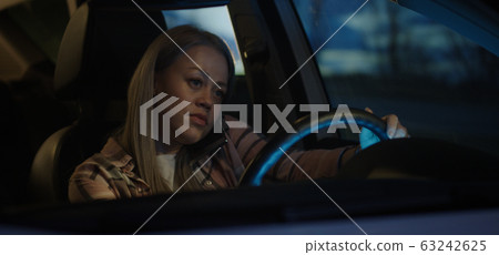 Woman phoning and traveling in car Woman phoning and traveling in car 63242625