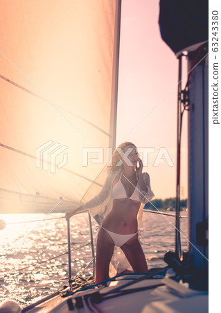 beautiful woman with a slim figure against the sky beautiful woman with a slim figure against the sky 63243380