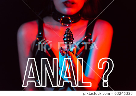 Concept of anal sex. Butt plug in the hands of a girl 63245323