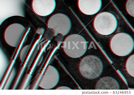 set of makeup brushes on a palette with colorful eye shadows set of makeup brushes on a palette with colorful eye shadows 63246953