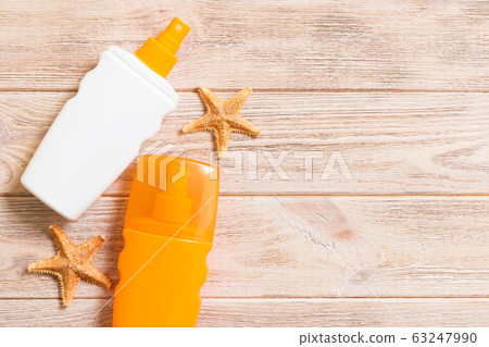 Top view of sunscreen bottle with starfish on Top view of sunscreen bottle with starfish on 63247990