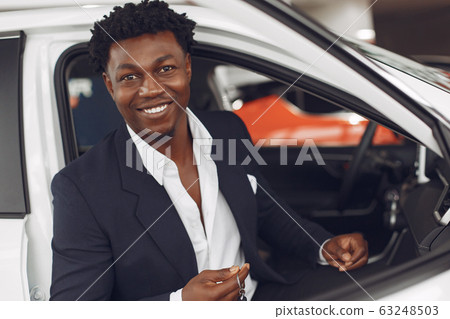 Handsome and elegant black man in a car salon Handsome and elegant black man in a car salon 63248503