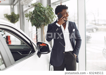 Handsome and elegant black man in a car salon 63248511