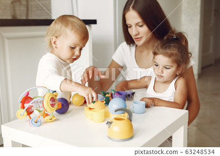 Mother with two children playing in a bathroom Mother with two children playing in a bathroom 63248534