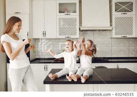 Beautiful family spend time in a kitchen Beautiful family spend time in a kitchen 63248535