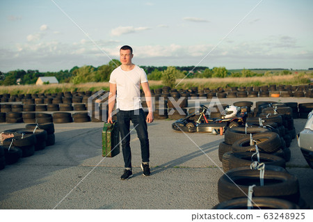 Handsome man in a karting with a car 63248925