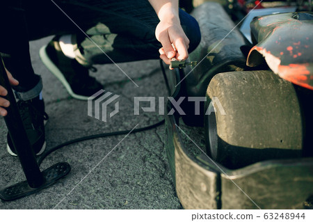 Handsome man in a karting with a car Handsome man in a karting with a car 63248944