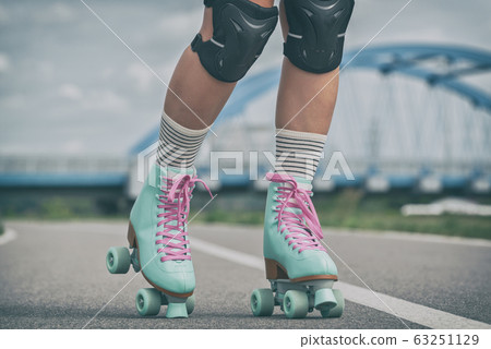 Woman rollerskater wearing knee protector pads Woman rollerskater wearing knee protector pads 63251129