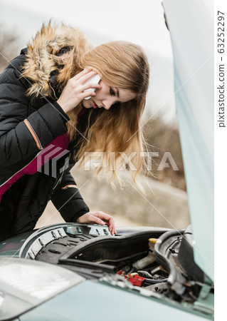 Broken down car, woman calling to somebody 63252297