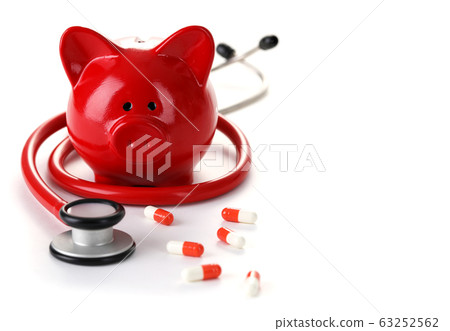 Around piggy bank are stethoscope and capsules Around piggy bank are stethoscope and capsules 63252562