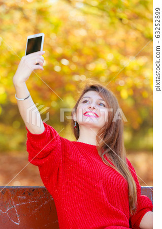 Gorgeous girl taking selfie. 63252899