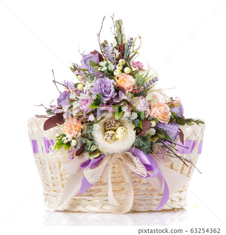 White basket decorated in Provence style with delicate flowers and ribbons on white background 63254362