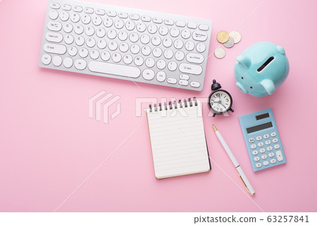 Saving money planning on pink desk 63257841