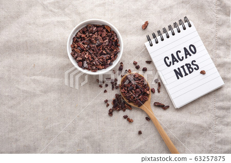 Cacao nibs on table, top view with copy space 63257875