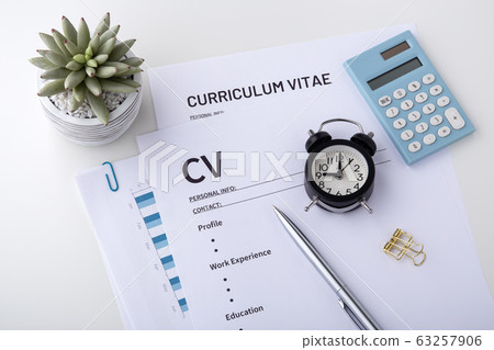 CV with pen and clock on white desk CV with pen and clock on white desk 63257906